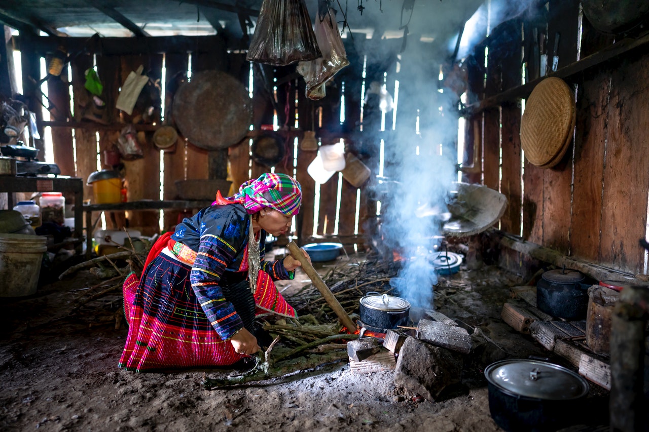 Woman-Tends-Fire This woman lives a very simple life with no electricity or internet. Her possessions are simple and few.