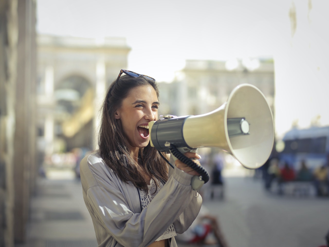 Lady with a megaphone announcing her plans to her friends. 